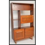 A retro vintage 1960's teak wood room divider bookcase having a configuration of open shelves and