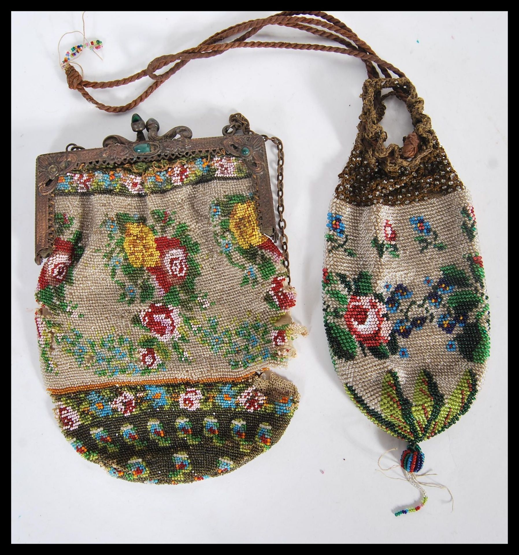 Two 19th Century Victorian beadwork purses, both having multi colour floral decoration. One having