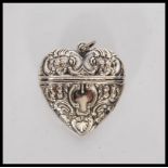 A silver heart shaped Vesta case having scroll and floral embossed decoration. Stamped 925. Weighs