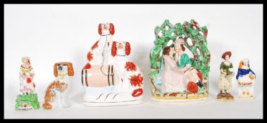 A selection of 19th Century Staffordshire flat back figurines to include a courting / just married