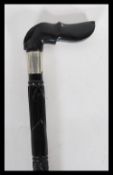 A 19th Century ebony walking stick cane with carved twisted shaft decoration having a handle to