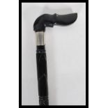 A 19th Century ebony walking stick cane with carved twisted shaft decoration having a handle to