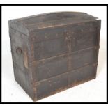 A vintage 19th century wooden and canvas bound steamer trunk. The dome top with open storage within.