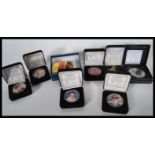 A collection of Elvis Presley U.S. silver eagle coins from the year 2002, along with an Elvis