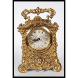 An early 20th Century gilt cast carriage clock, the clock cast in relief in the rococo taste