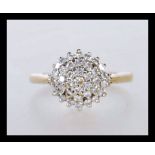 A hallmarked 9ct gold cluster ring set with white stones. Hallmarked Birmingham. Weight 2.0g. Size