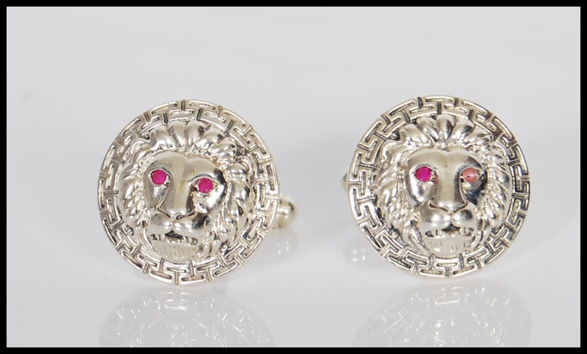 A pair of Versace style stamped sterling silver gentleman's cufflinks in the form of lion heads,