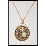 A stamped 9ct gold necklace having a fine rope twist chain having a 1981 gold Charles and Diana coin