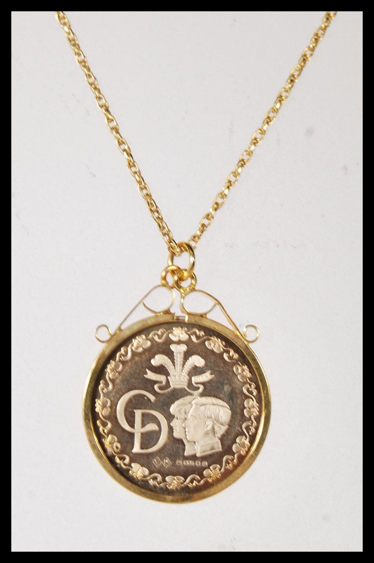 A stamped 9ct gold necklace having a fine rope twist chain having a 1981 gold Charles and Diana coin