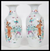 A matching pair of early 20th Century vases of baluster form, being hand painted decorated in