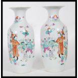 A matching pair of early 20th Century vases of baluster form, being hand painted decorated in