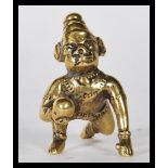 A 19th Century cast Indian gilt bronze figurine of Balakrishna in the crawling pose hold a butter