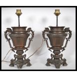 A pair of late 19th Century French bronzed spelter urns having a later conversion to table lamps. Th