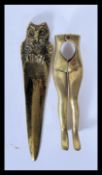 A pair of 20th Century brass nut crackers in the form of a pair of female legs together with a brass