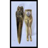 A pair of 20th Century brass nut crackers in the form of a pair of female legs together with a brass