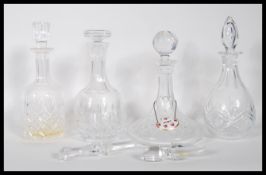 A group of 20th Century cut crystal glass decanters to include, a ships decanter having round cut