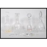 A group of 20th Century cut crystal glass decanters to include, a ships decanter having round cut