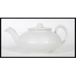 An 19th century Wedgwood caneware teapot having basket weave moulding, the flat lid with