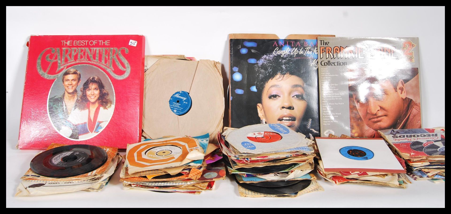 A collection of 45rpm vinyl 7" singles featuring various artist to include Boney M, Elvis Presley,