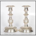 A pair of early 20th Century style silver plate candlesticks having engraved geometric decoration