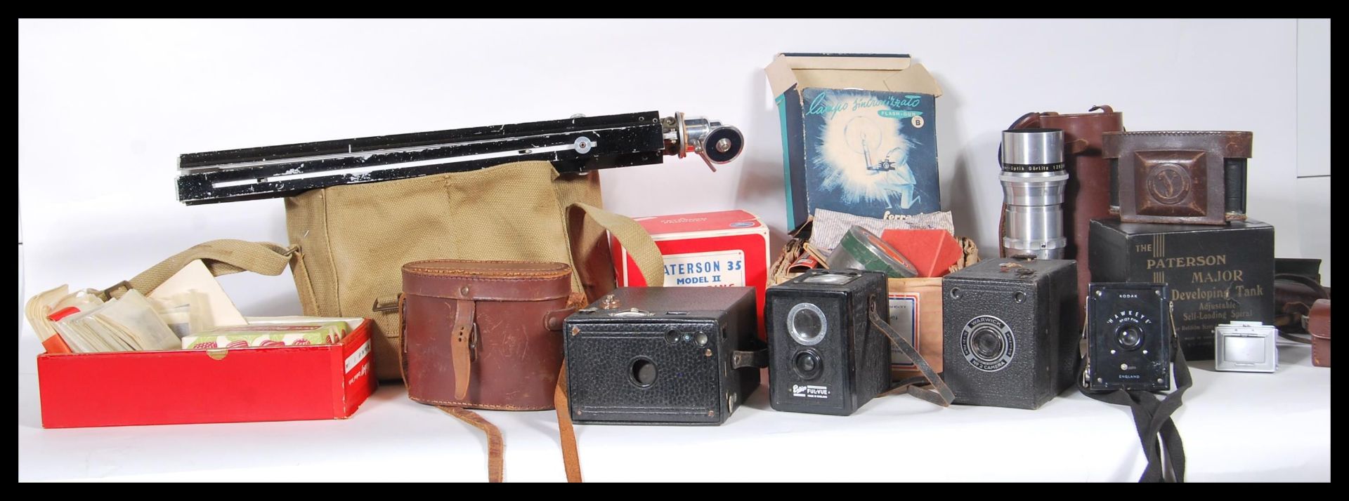 A collection of vintage film cameras and equipment to include a selection of boxed cameras including
