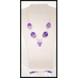 A demi parure necklace and earrings set to include a necklace set with  five purple agate