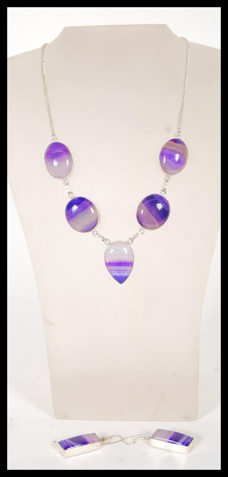 A demi parure necklace and earrings set to include a necklace set with  five purple agate