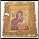 A 20th Century icon of Mary and the Infant Jesus set within a 19th Century ornate gesso gilt