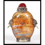 A 19th century Chinese glass perfume scent bottle having light red ground and oriental scene