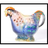 A early 20th Century 1920's novelty teapot in the form a rooster having bright coloured feathers.