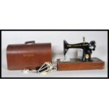 A 20th Century vintage cased Singer sewing machine, having later conversion to electric. The machine