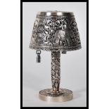 A 20th Century silver/ white metal table lighter in the form of table lamp, having decorative