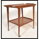 A vintage retro Mid 20th Century Danish style teak hostess trolley having two rectangular tiers with