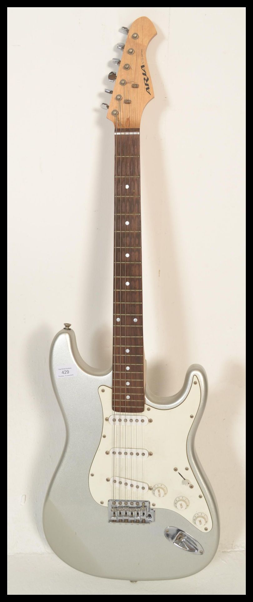 An Aria six-string STG Series electric guitar, silver body with white scratch guard and pick up. - Bild 2 aus 5