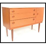 A vintage 1970's teak wood veneer sideboard credenza, having a configuration of three drawers to the