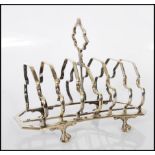 A 19th Century style silver plate six sectional toast rack raised on ball and claw feet.