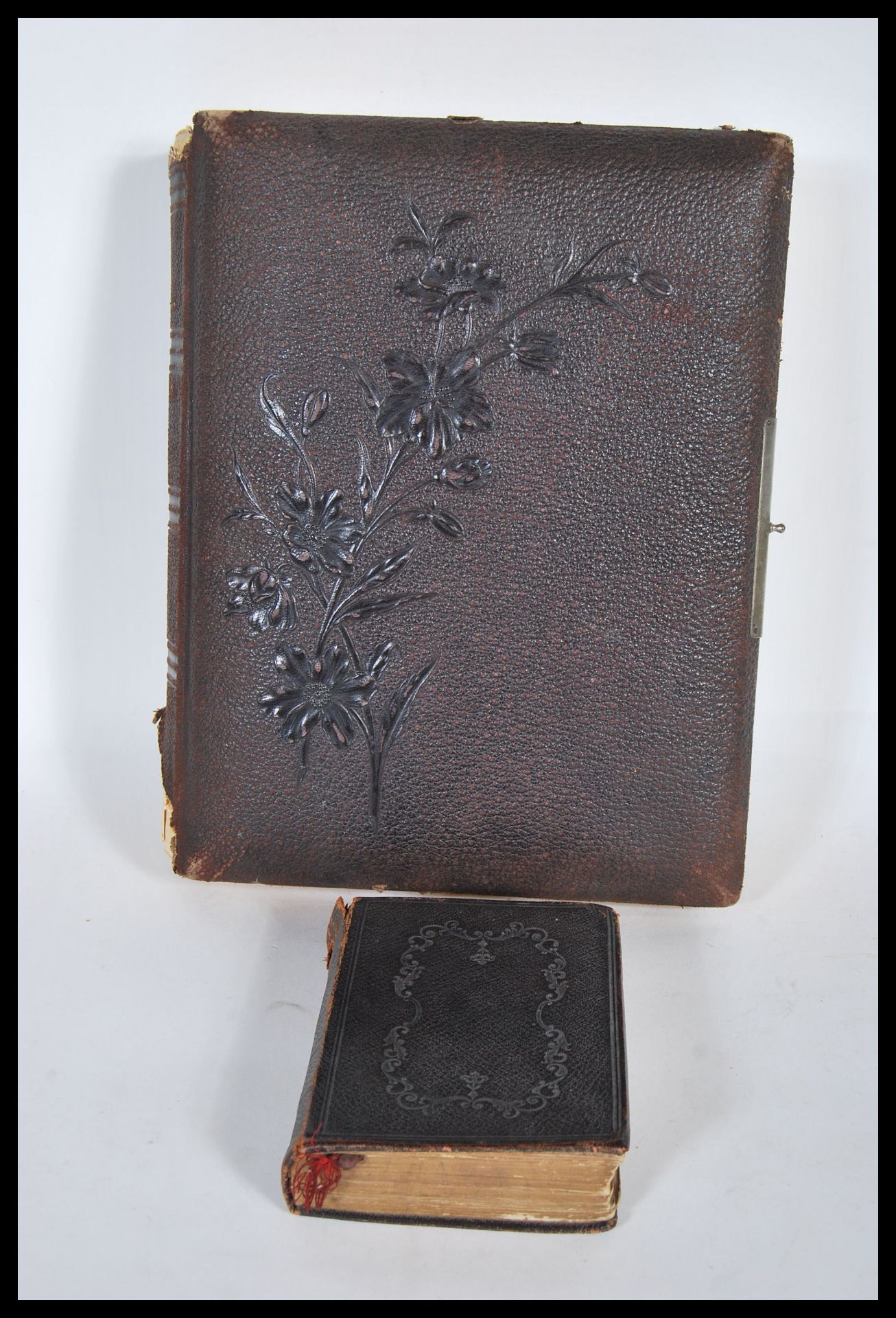A 19th Century Victorian photograph album bound in brown leather with gilt edging, mostly containing