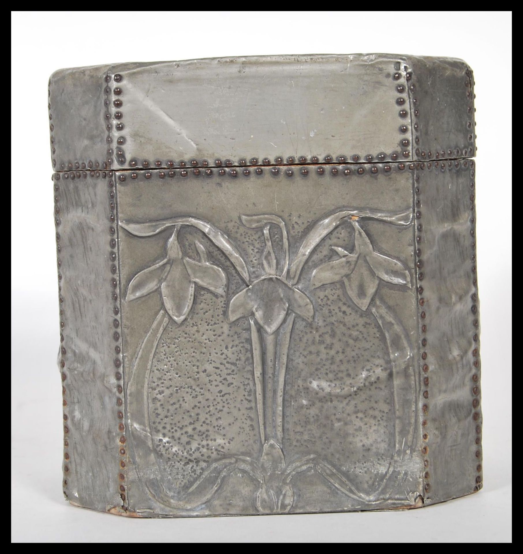A late 19th century Arts and Crafts hammered pewter bound octagonal wooden tea caddy with hinged