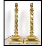 A pair of 20th Century tall brass twist column table lamps in the form of candlesticks, the