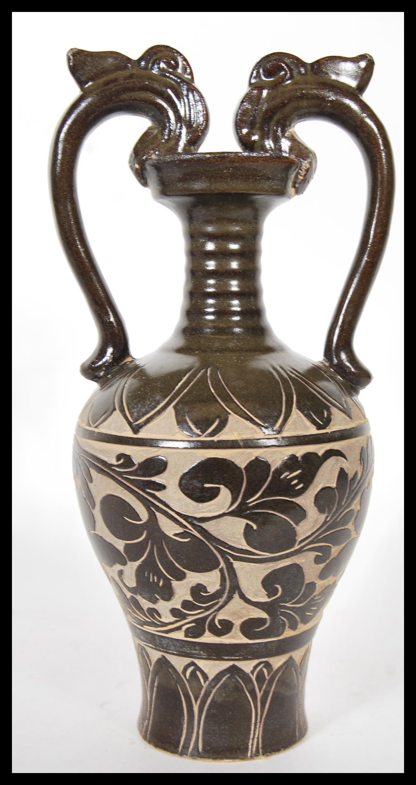 A Chinese stoneware vase / urn having shaped twin handles with floral relief decoration to the - Image 3 of 6