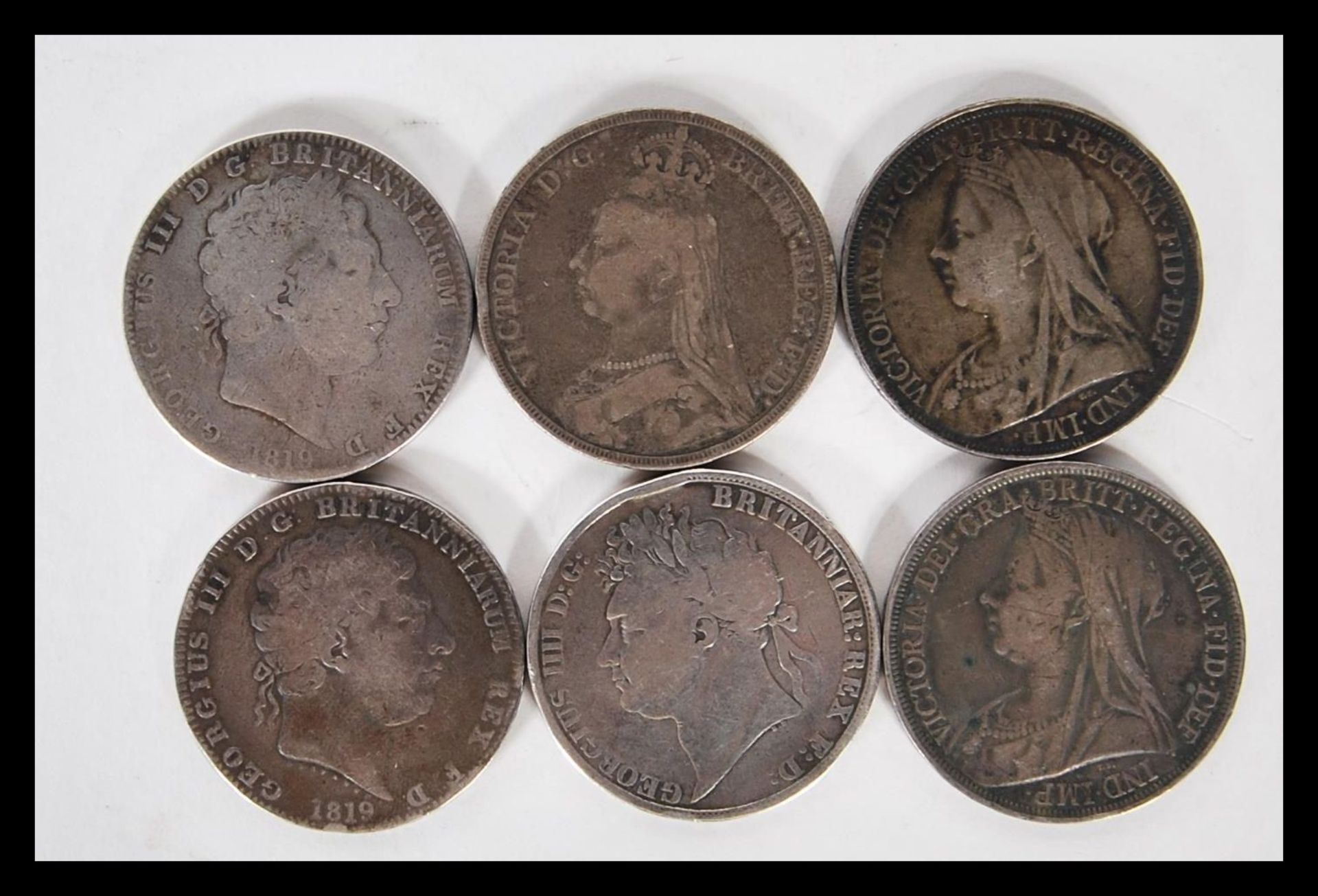 A collection of six silver crowns dating the early 19th Century to include three George II crowns