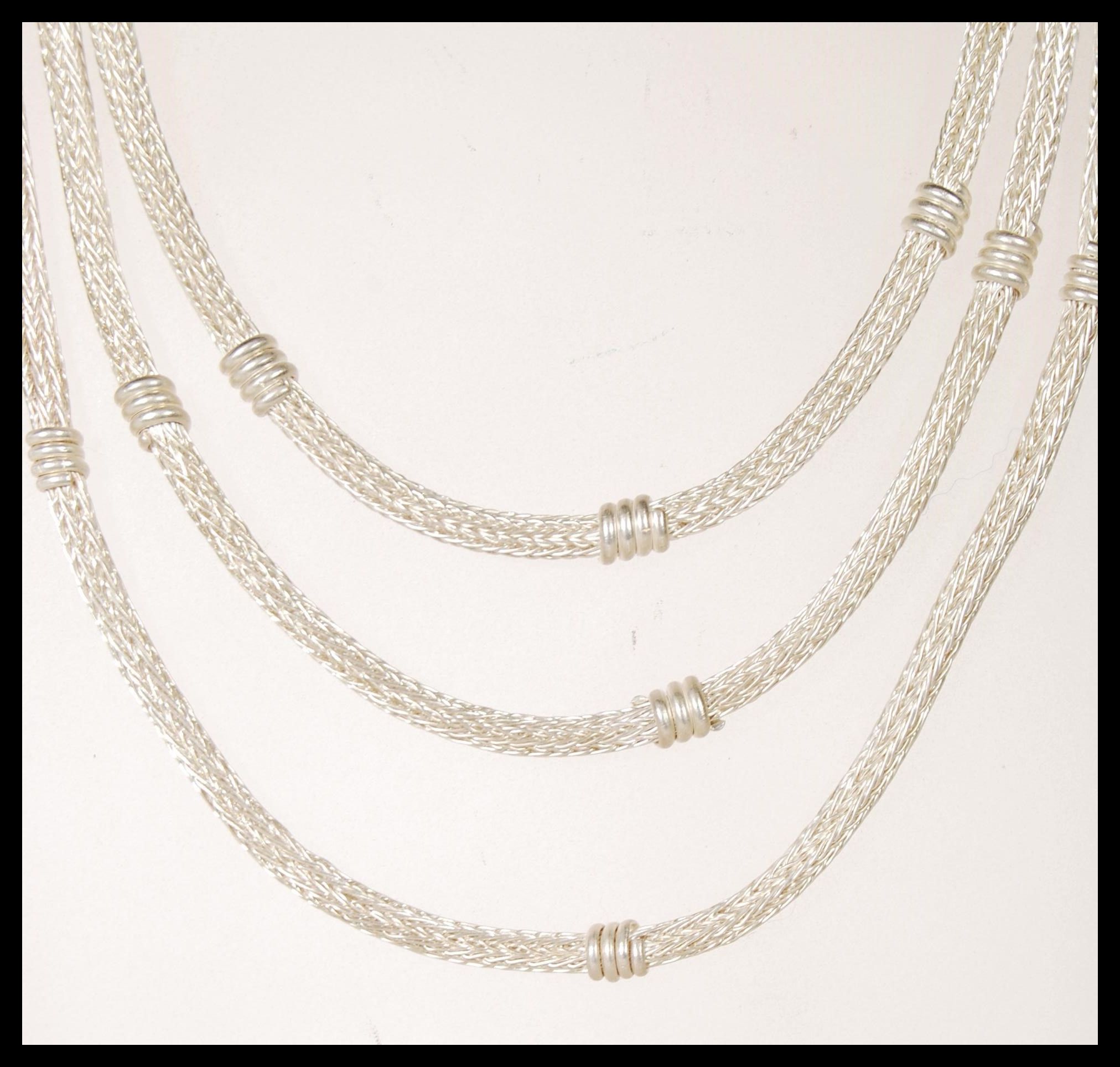 A 20th Century silver ethnic style necklace having three graduating snake chains with floral - Image 2 of 5