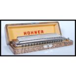 A vintage cased M. Hohner ' the 64 Chromonica ' German professional harmonica, in 4 chromatic