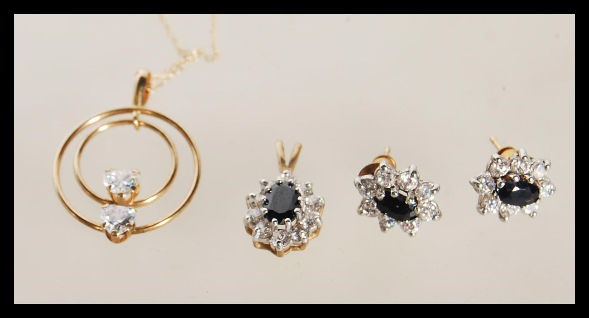 A selection of stamped 9ct gold jewellery to include a pendant necklace having a circular pendant