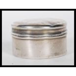 An early 20th Century silver hallmarked dressing table pillbox of round form. Hallmarked