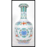 A 20th Century Chinese vase having wasted neck falling into a bulbous body, being Wucai having