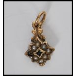 A 19th Century Georgian gold mourning pendant in the form of a star being set with a central green