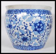 A large 20th Century ceramic planter pot of bulbous form having having painted blue floral