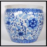 A large 20th Century ceramic planter pot of bulbous form having having painted blue floral