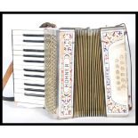 A 20th Century Hohner Student ll (2) piano accordion, having its original leather strap and original